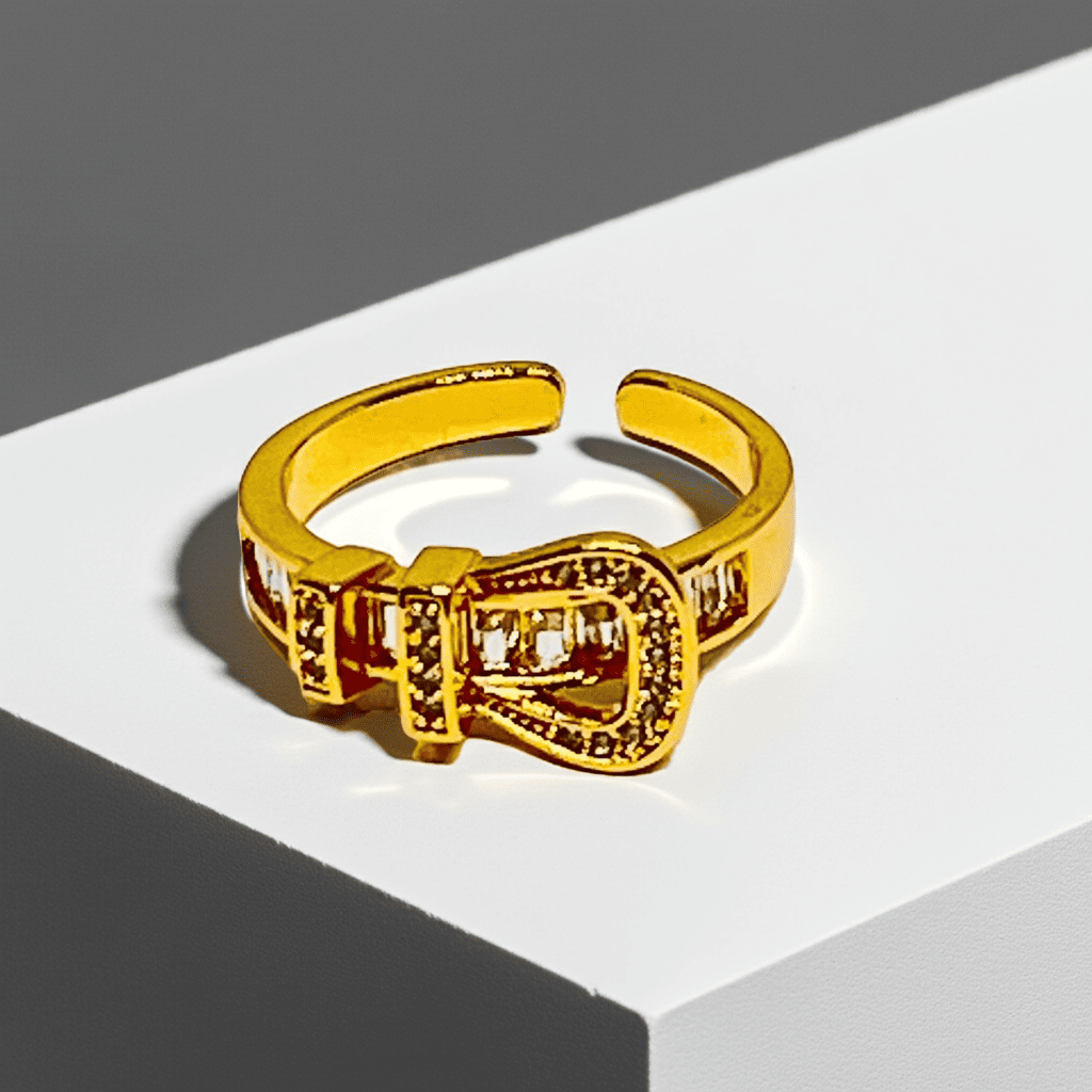 18k Gold ring with a unique buckle design on a white surface