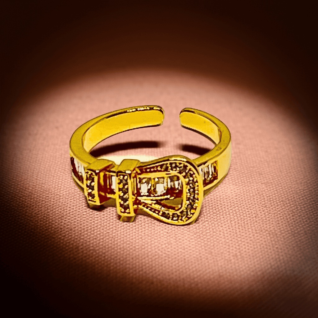 18k Gold ring with a buckle design on a brown textured background