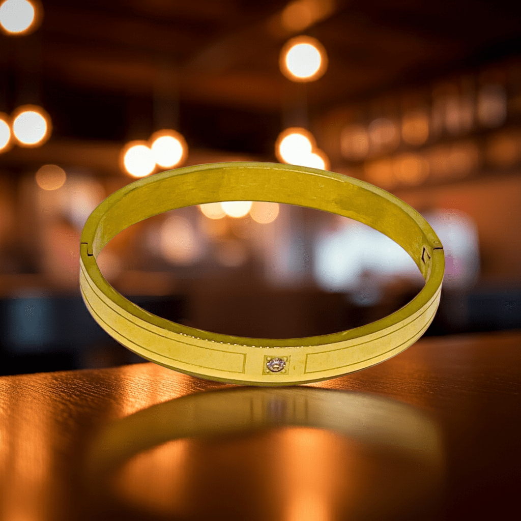 Yellow bracelet on a reflective surface with blurred lights in the background