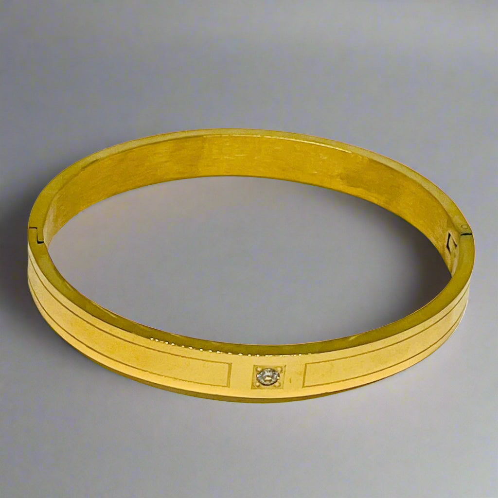 18K gold-plated bangle bracelet with a single sparkling stone, sleek and elegant jewelry for women, perfect for gifting or special occasions.