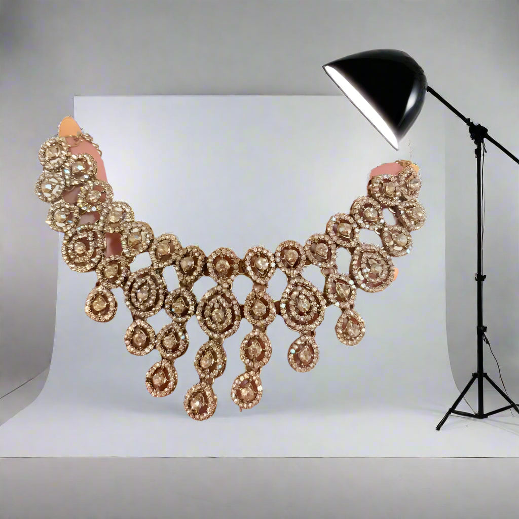 Decorative necklace held by a hand against a plain background