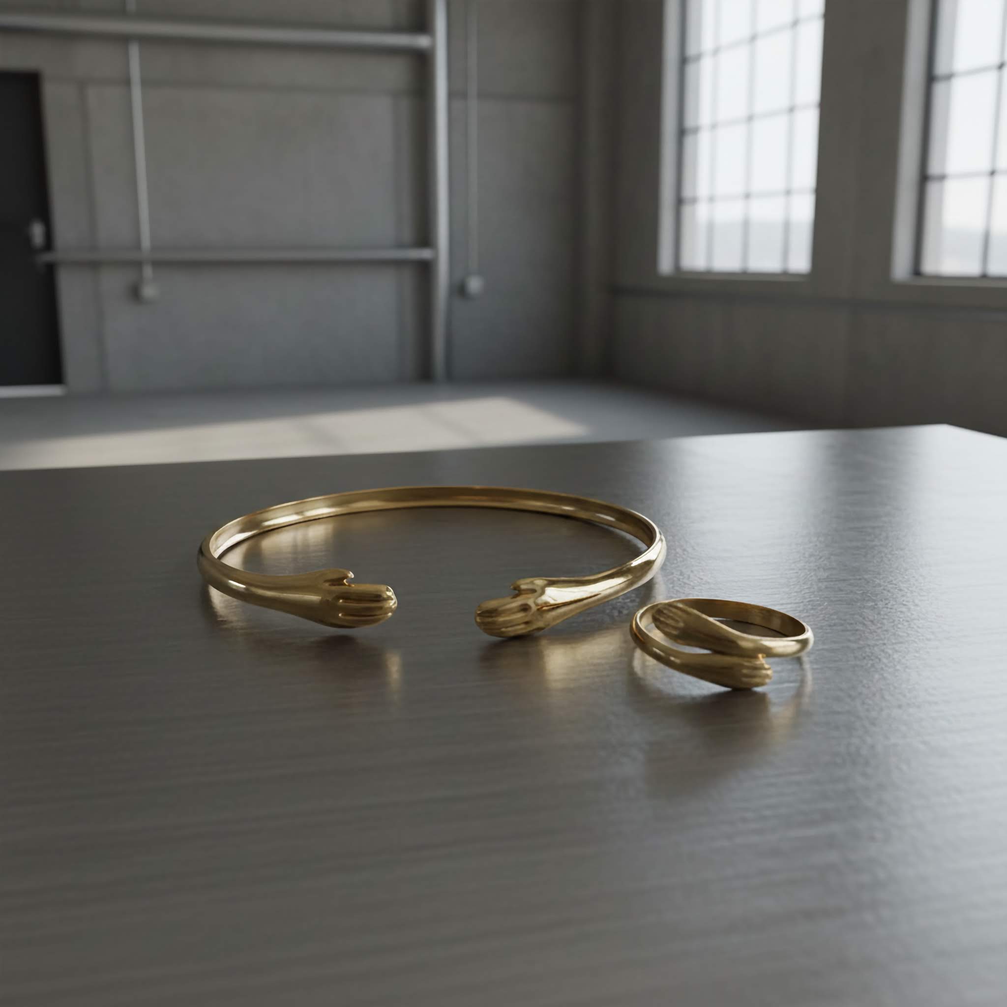 18k Gold plated bracelet and ring on a metal surface with a neutral background
