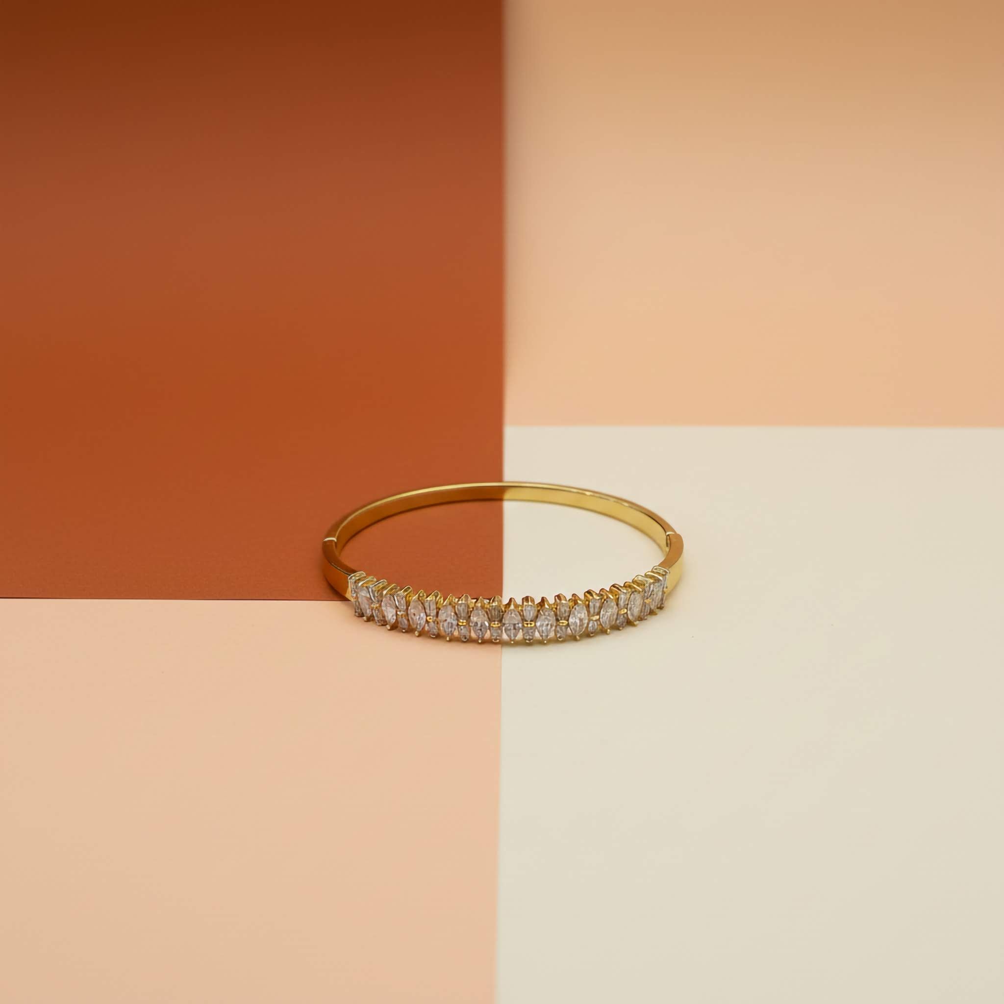 18k Gold plated bracelet with zirconia diamond stones on a two-tone background