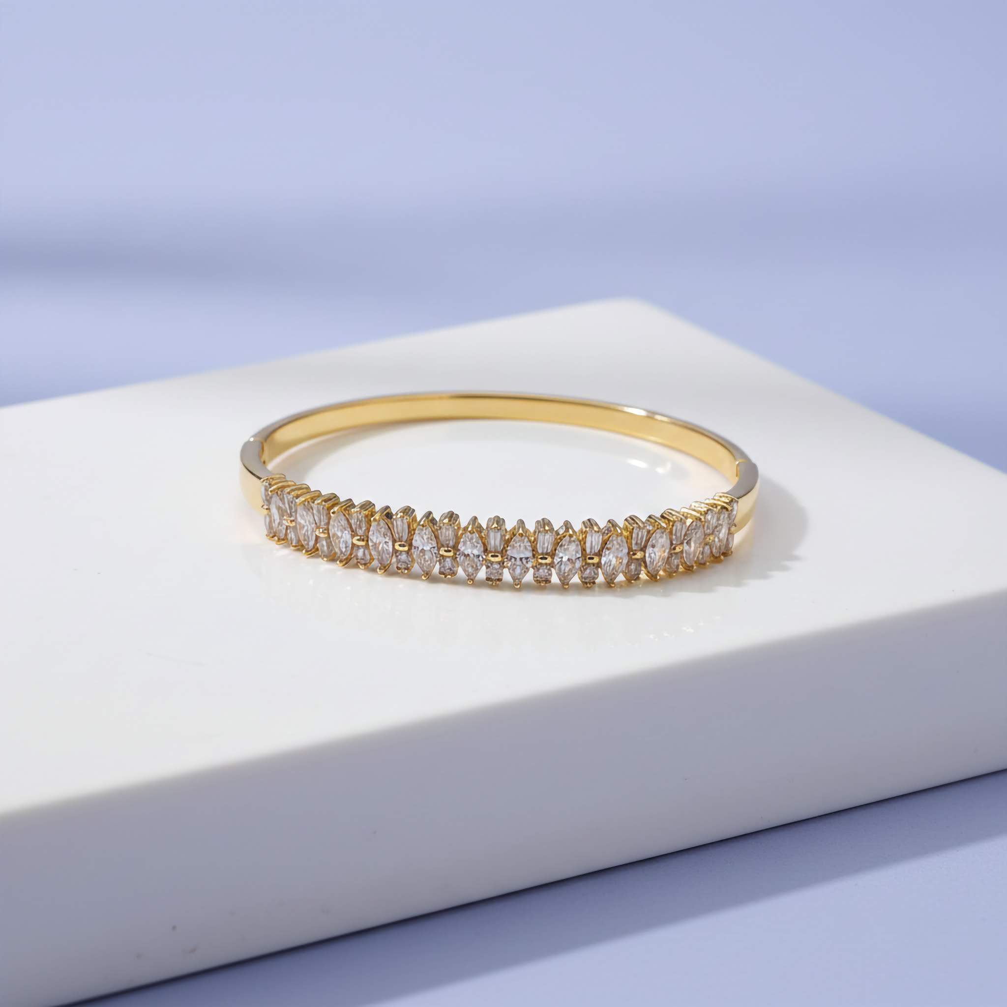 18k Gold plated bracelet with zirconia diamonds on a white platform with a light purple background