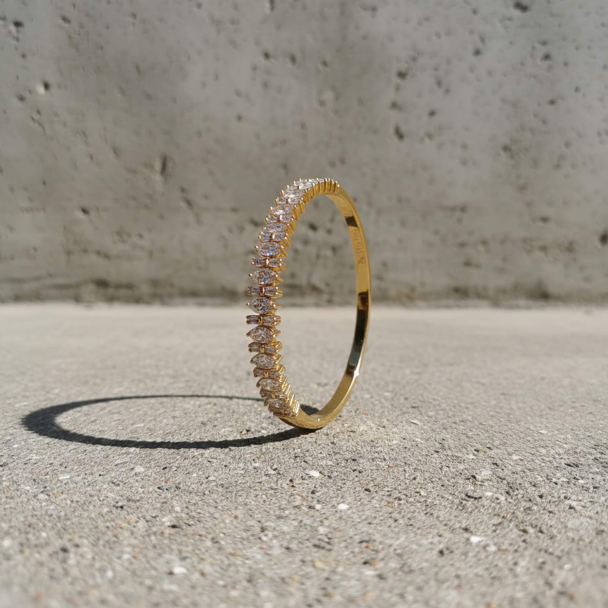 18k Gold plated bracelet with zirconia diamonds on a textured surface