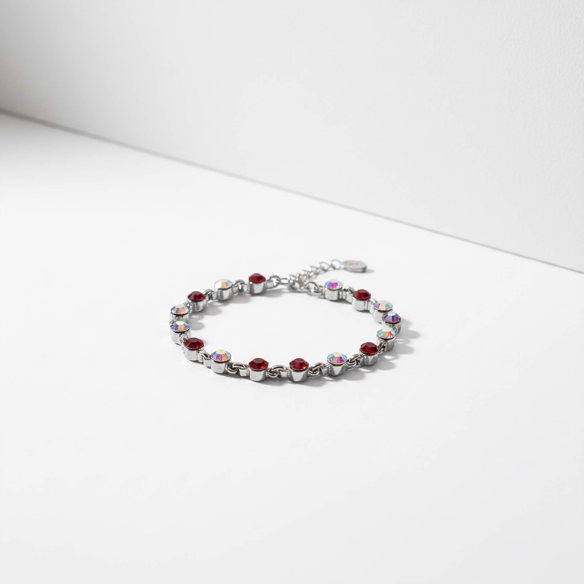 Bracelet with red and clear gemstones on a white background