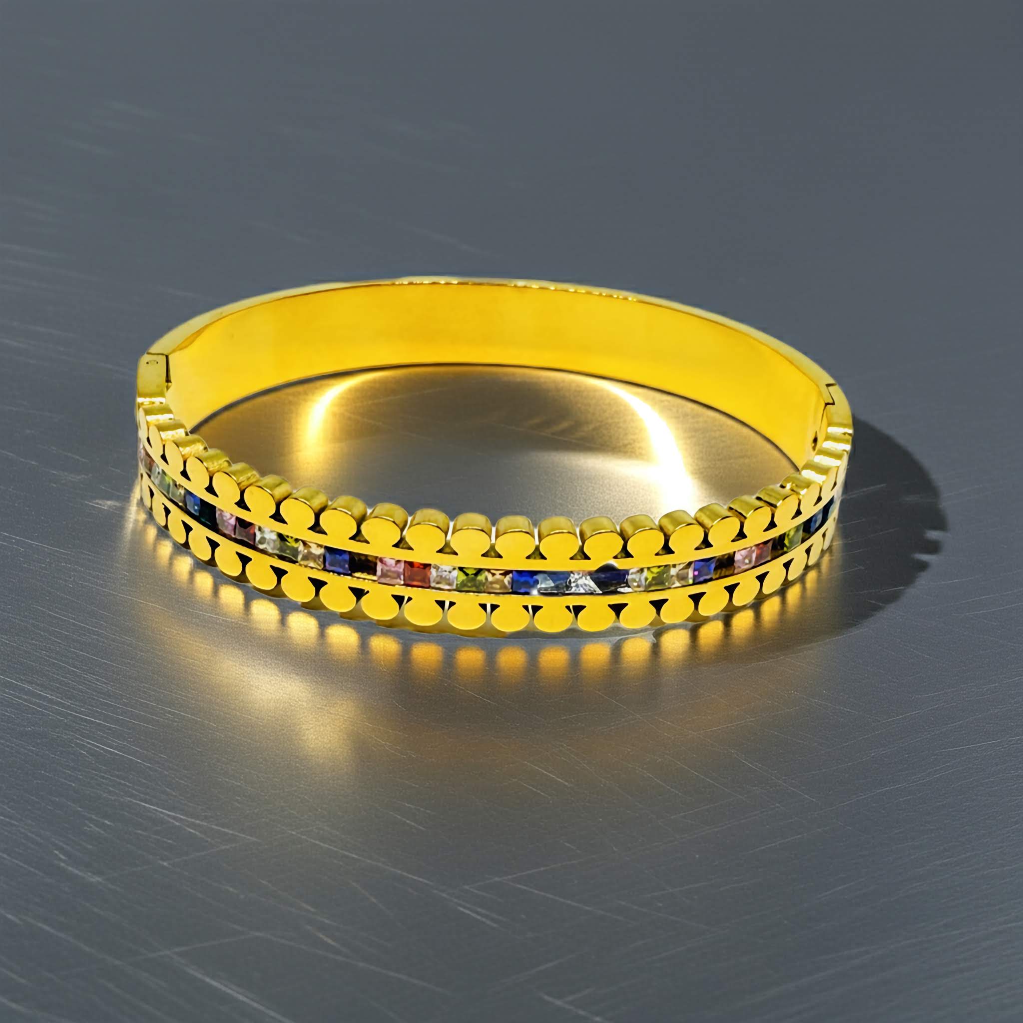 A 18k Gold plated bracelet with embedded colorful stones on a metallic surface