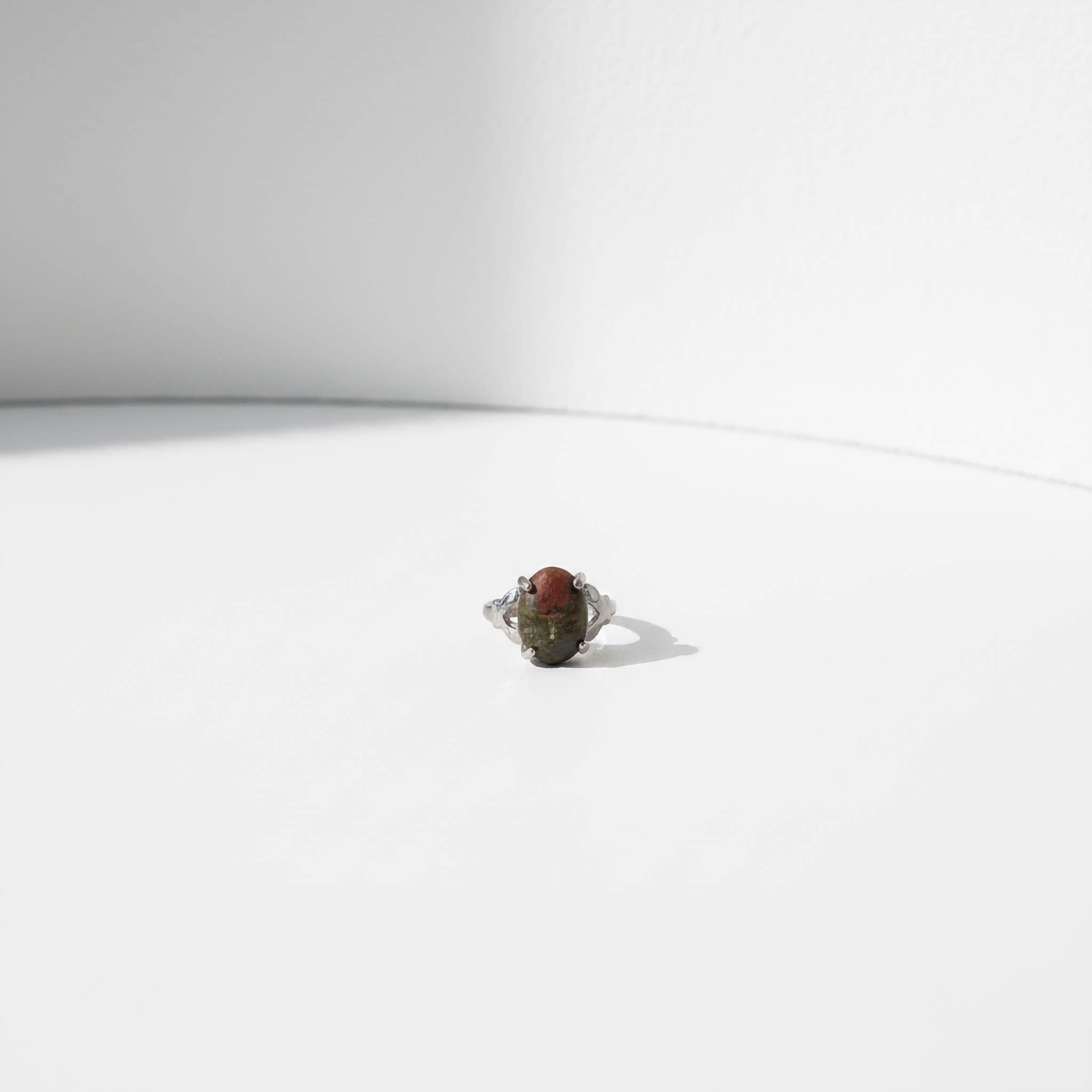 Green/brown mix Ring with a stone on a white background