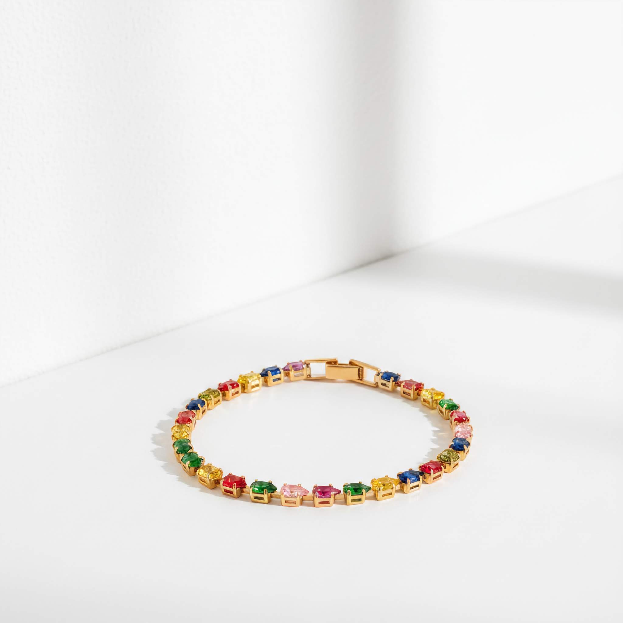 Multicolored gemstone tennis bracelet on a white background