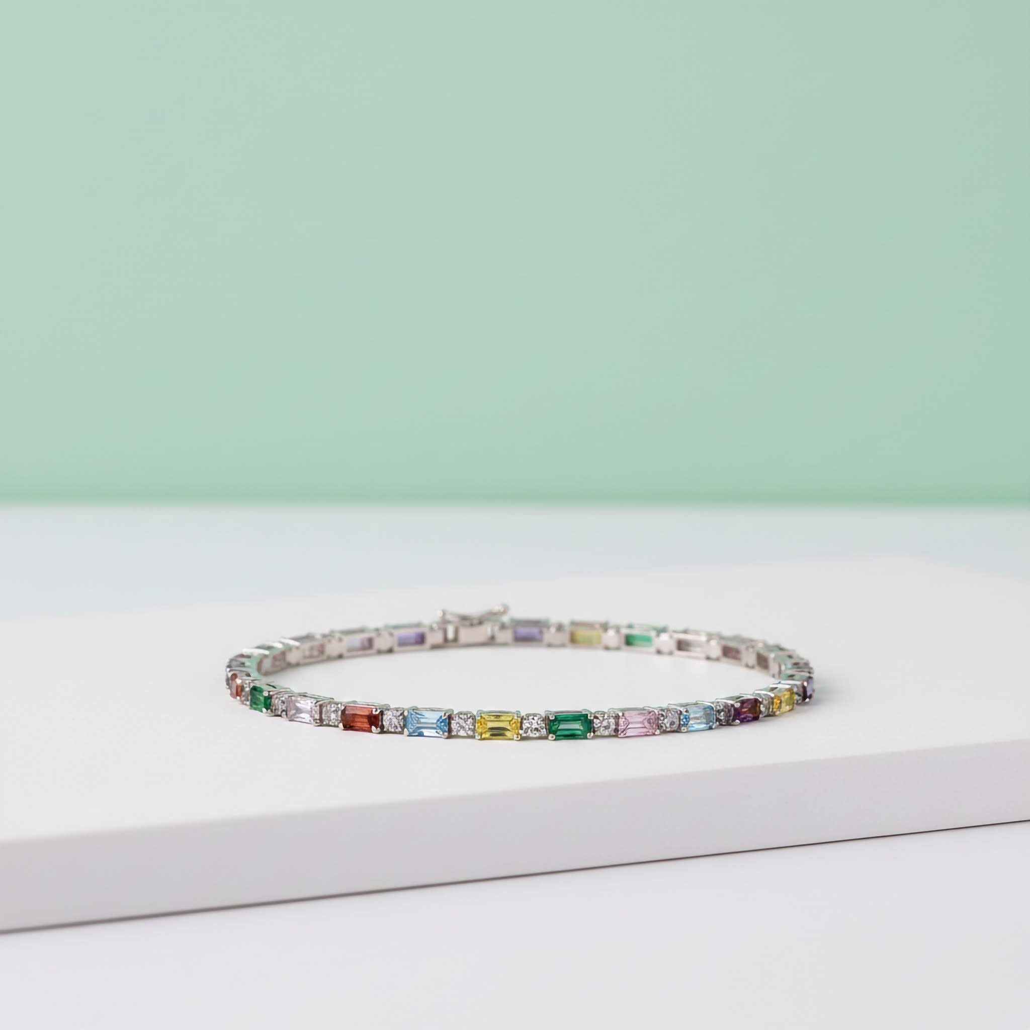 Multicoloured gemstone bracelet on a light green and white background