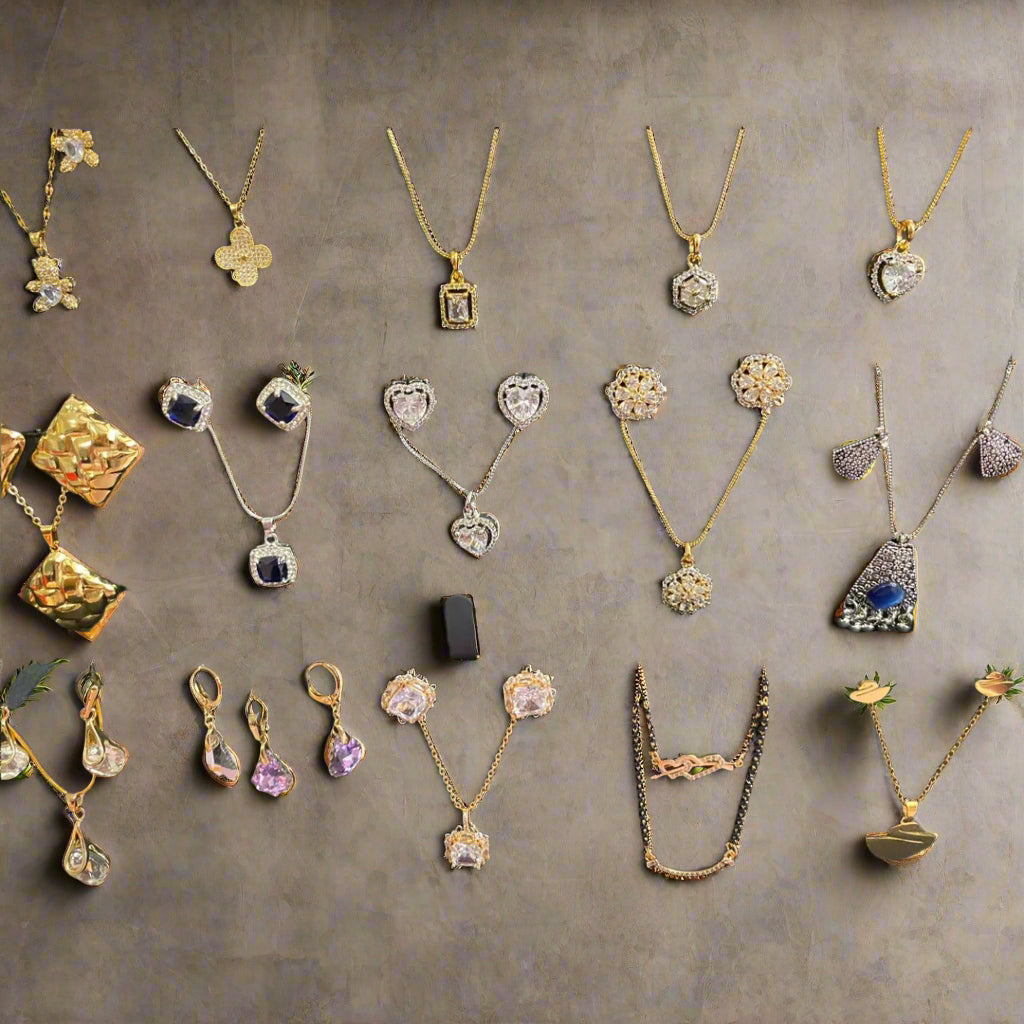 Collection of gold and silver necklaces on display with a black background