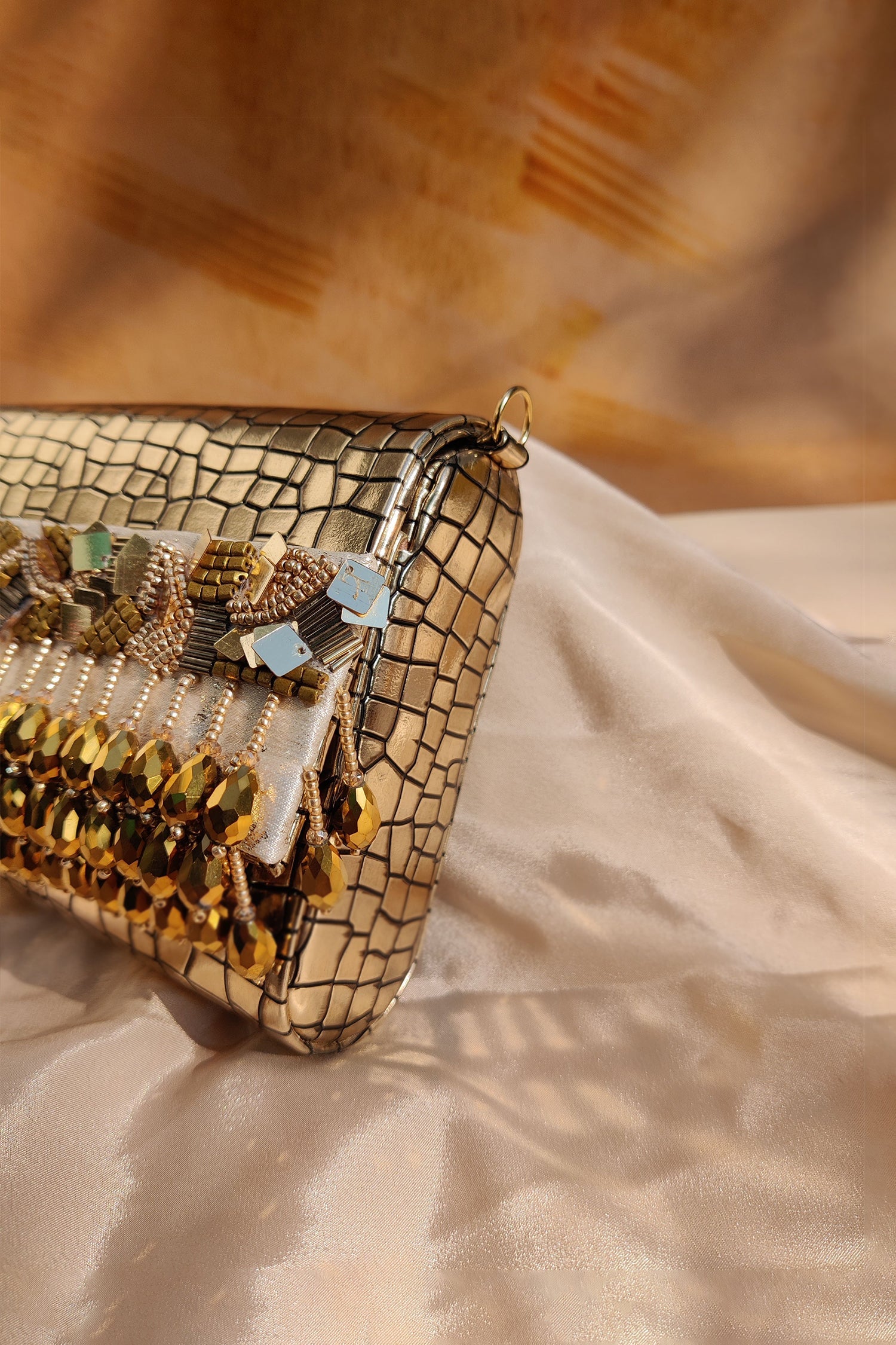 NOORIE GOLD HANDHELD CLUTCH