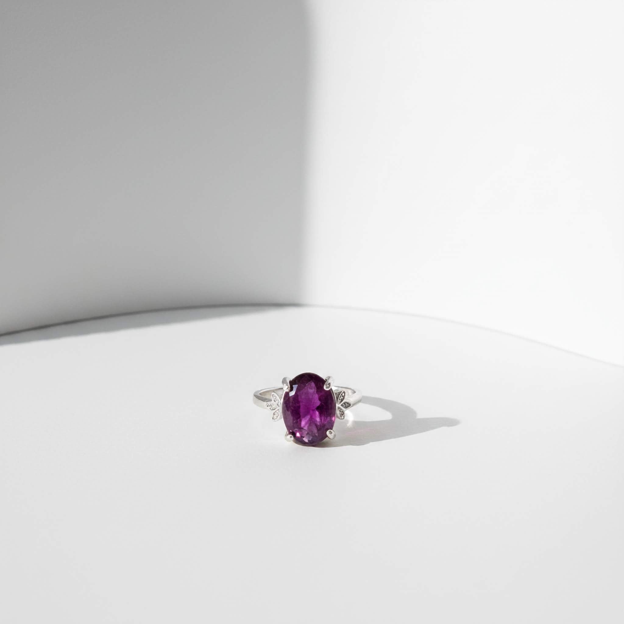 Ring with a purple gemstone on a white background