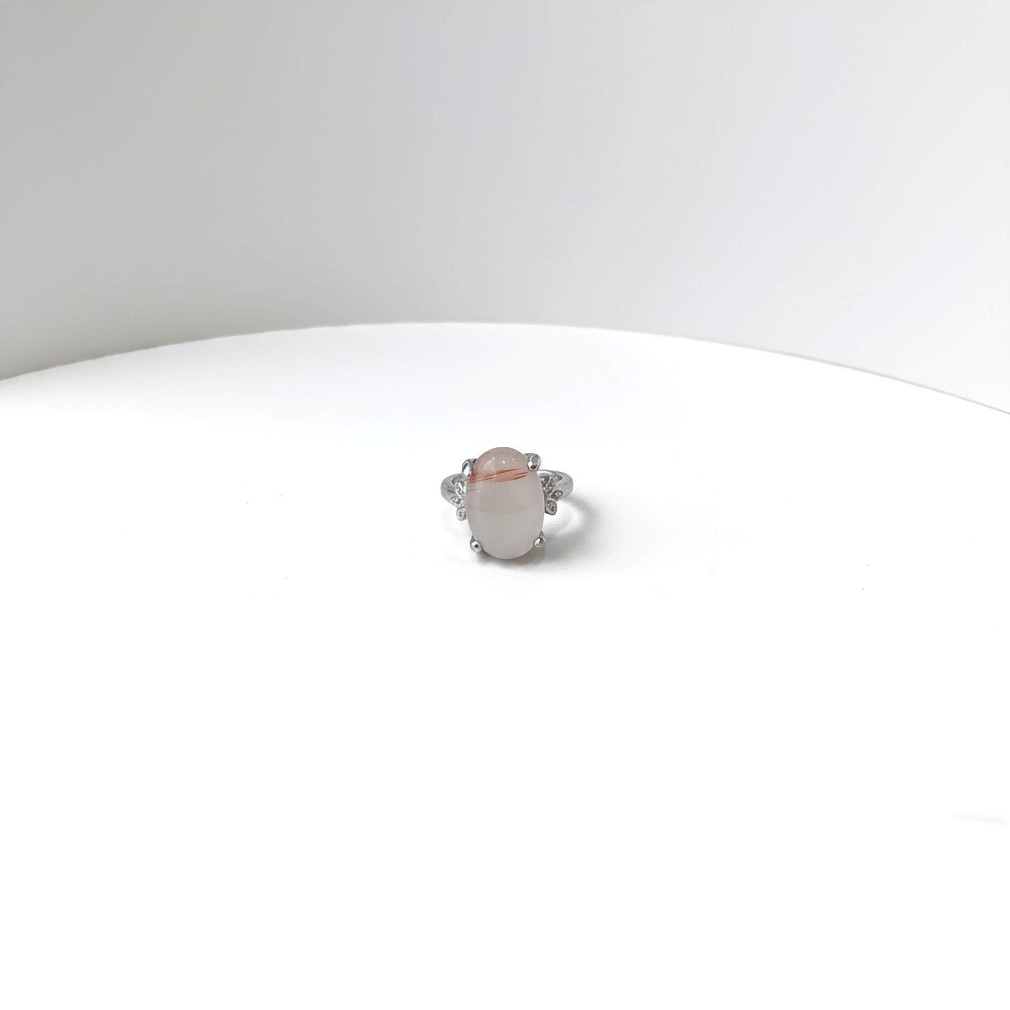 Silver Ring with a light gradient gemstone on a white background