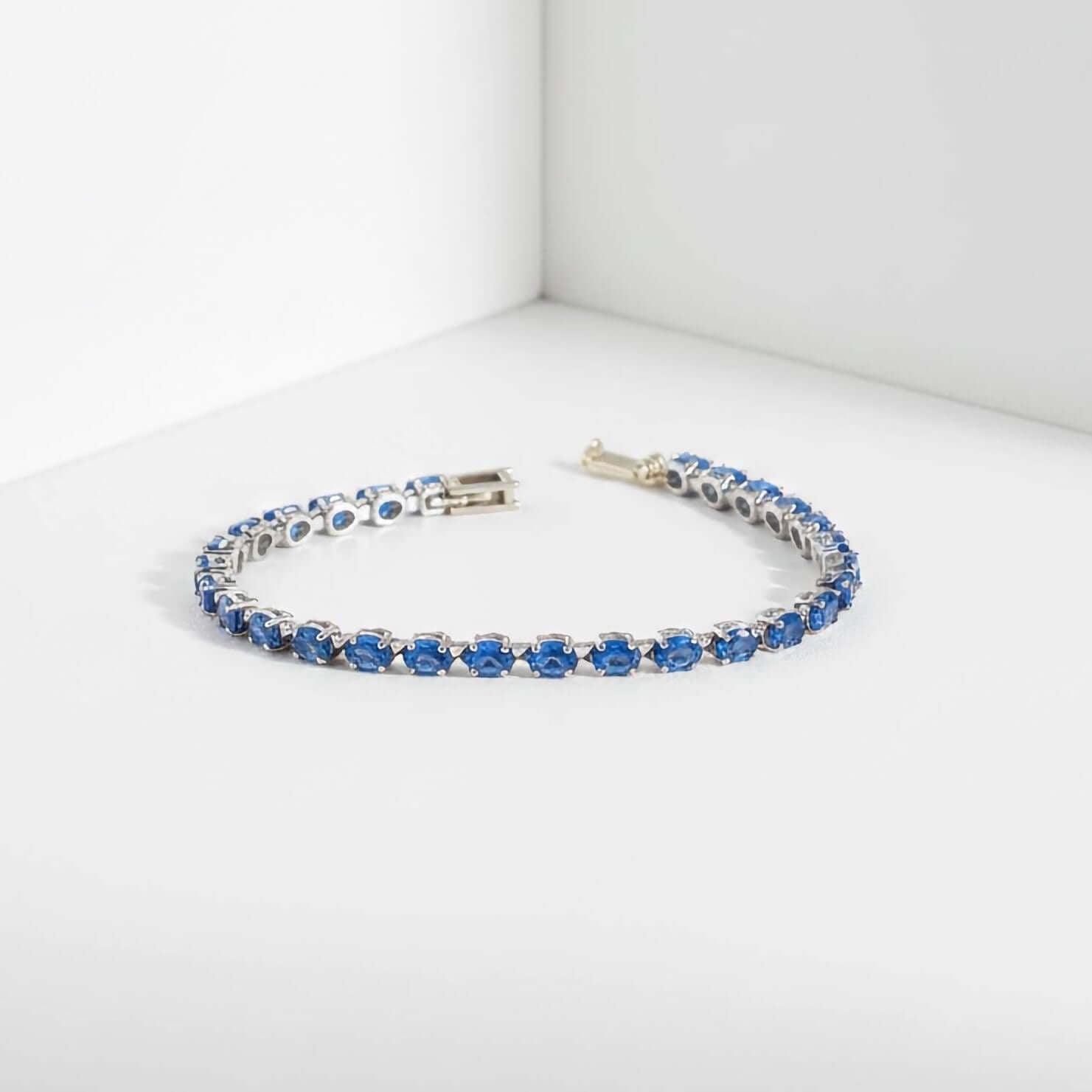 Luxury Statement Jewelry Bracelets  collection Silver bracelet with blue gemstones on a white background