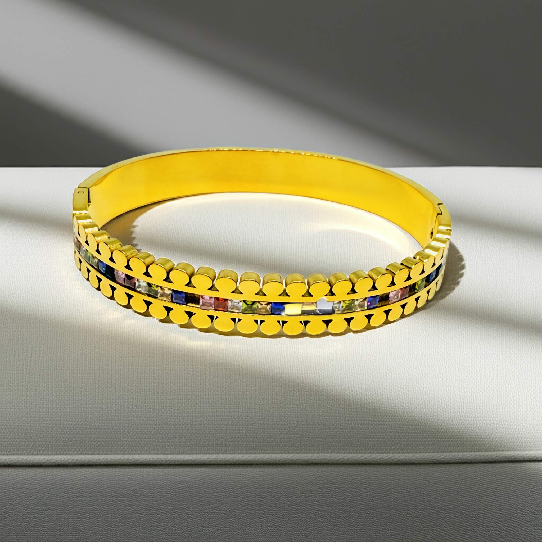  A Elegant Gold plated bracelet with colorful stones on a light surface