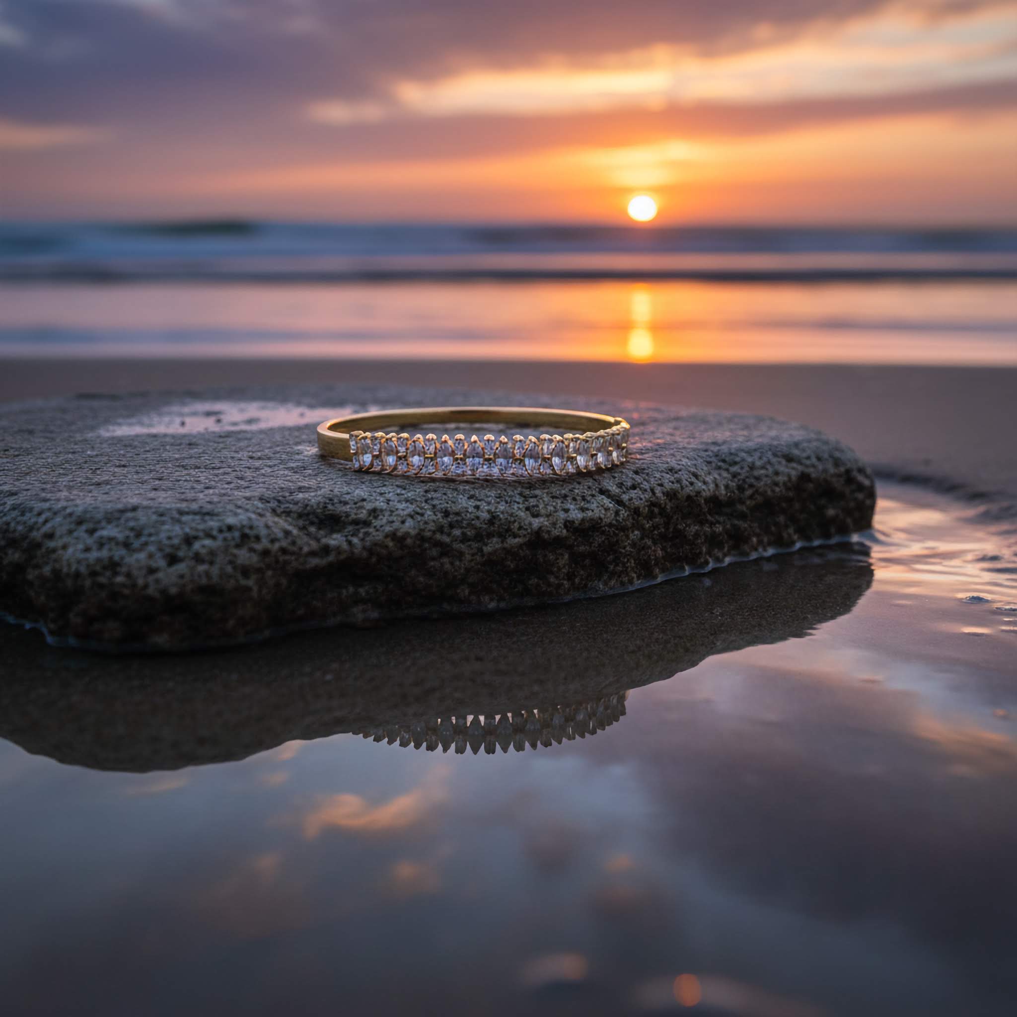 Zirconia diamonds bracelet on a rock with a sunset over water in the background