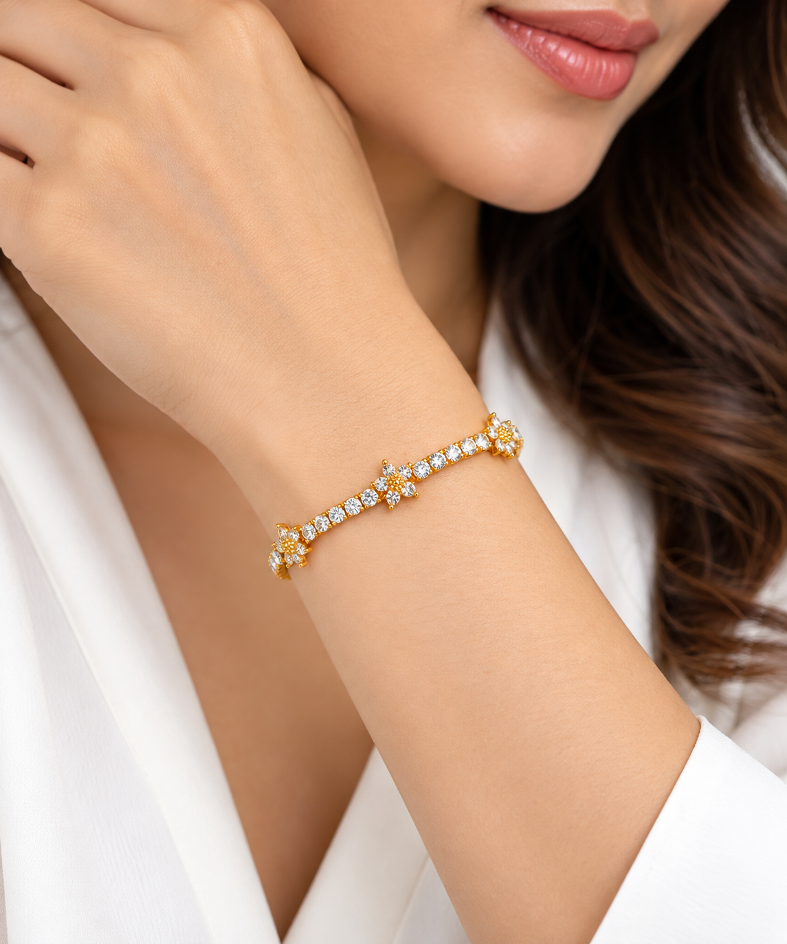 Model wearing LeDeSaRa gold-tone floral cubic zirconia tennis bracelet on wrist