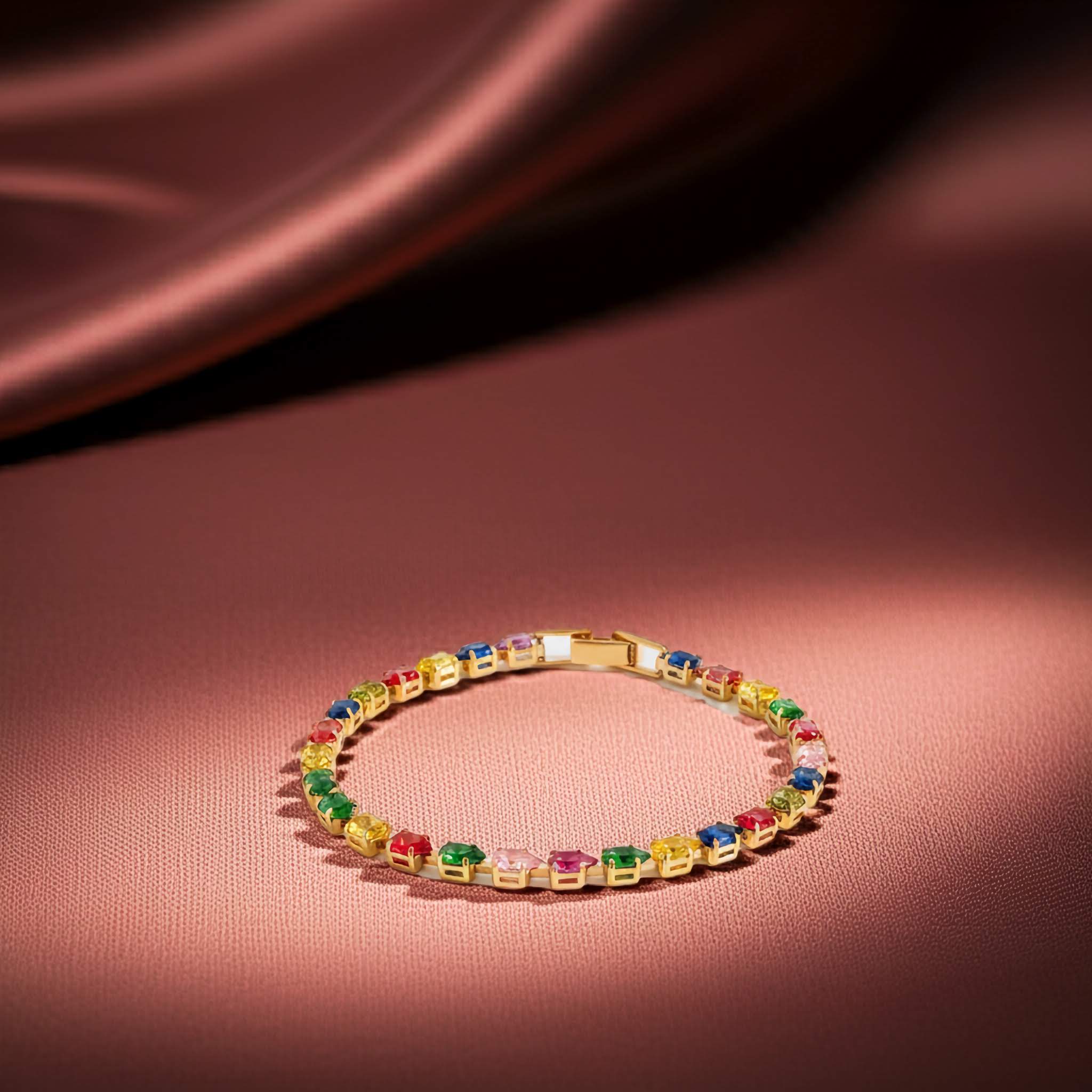 Multicolored gemstone bracelet on a pink satin background